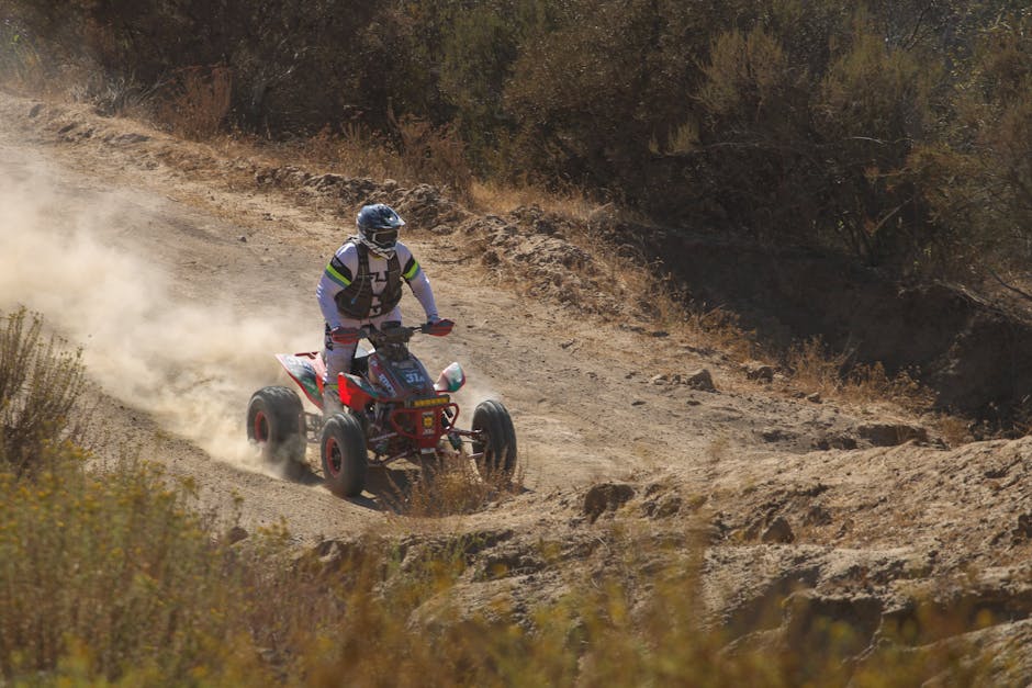 A thrilling off-road ride on a dusty desert trail with a quad bike.